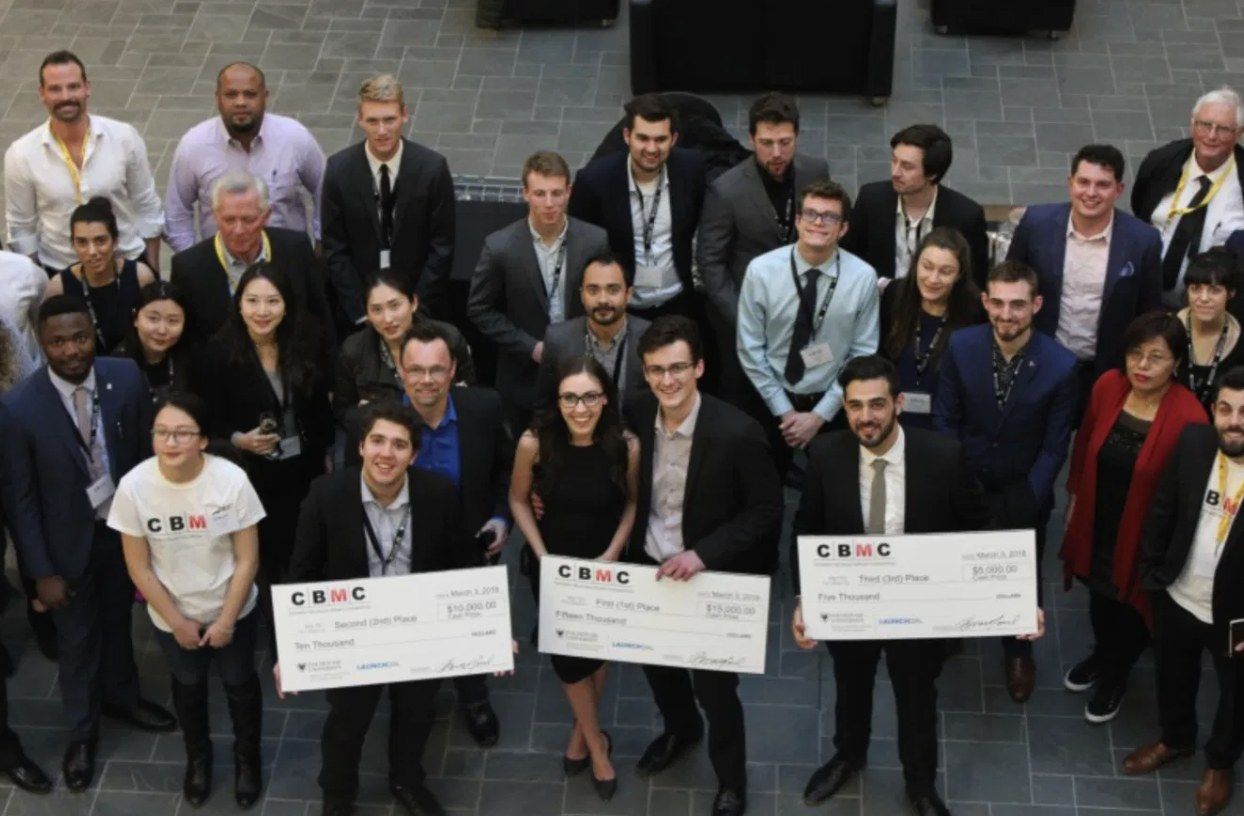 Winners of Canada's Business Model Competition 2018 holding prize cheques.