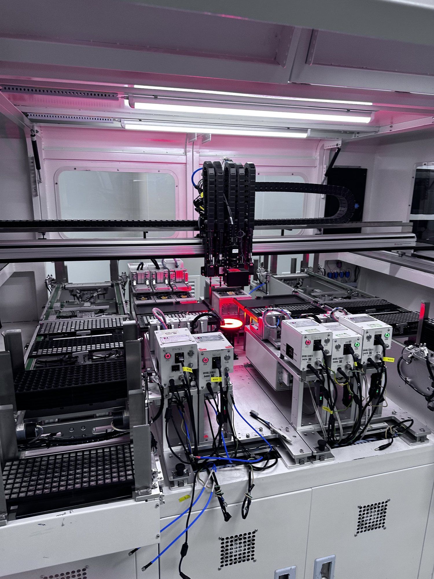 A circuit board assembly machine lit up inside the factory.