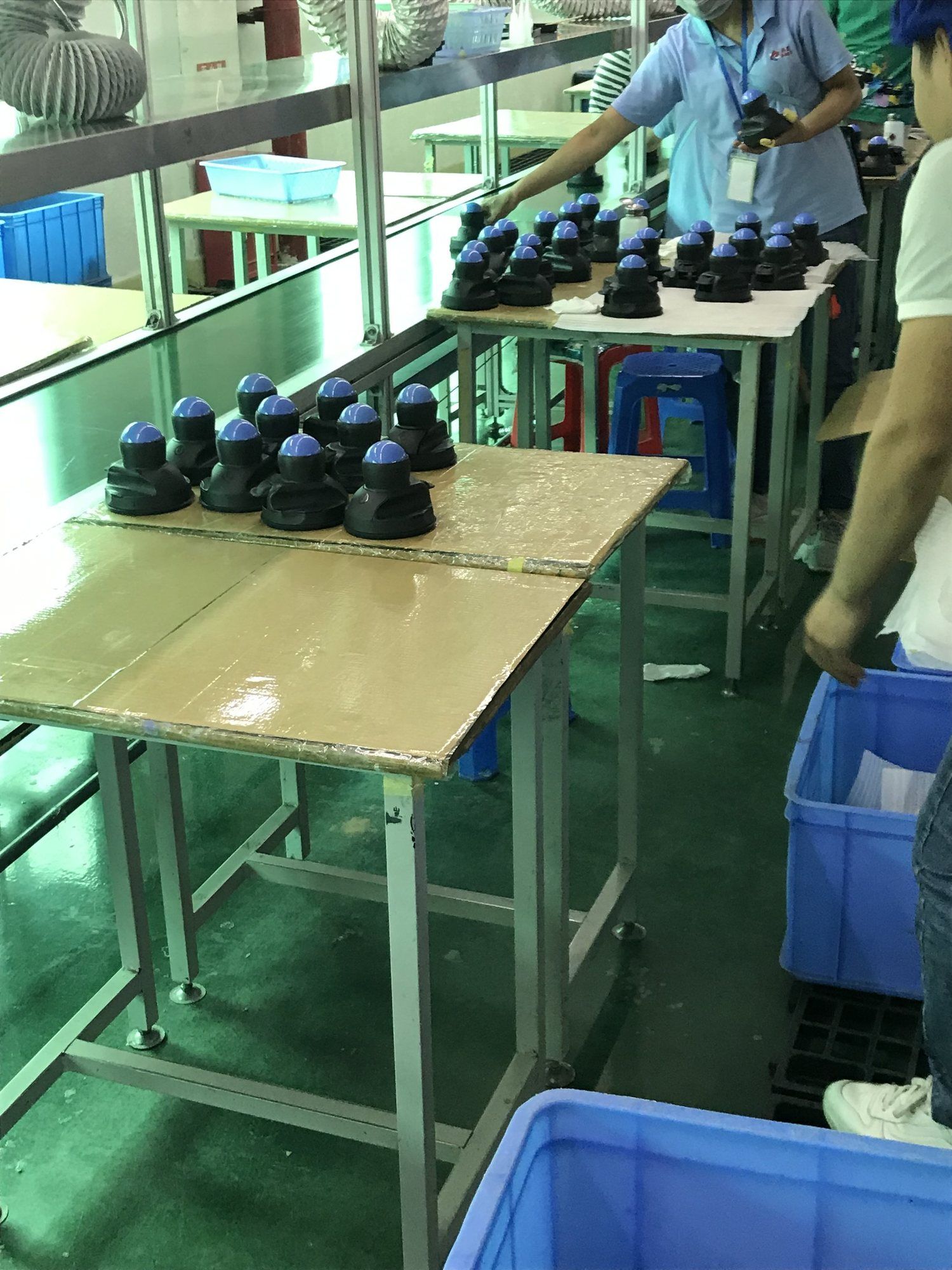 Rows of Vertiballs on assembly tables in a factory.