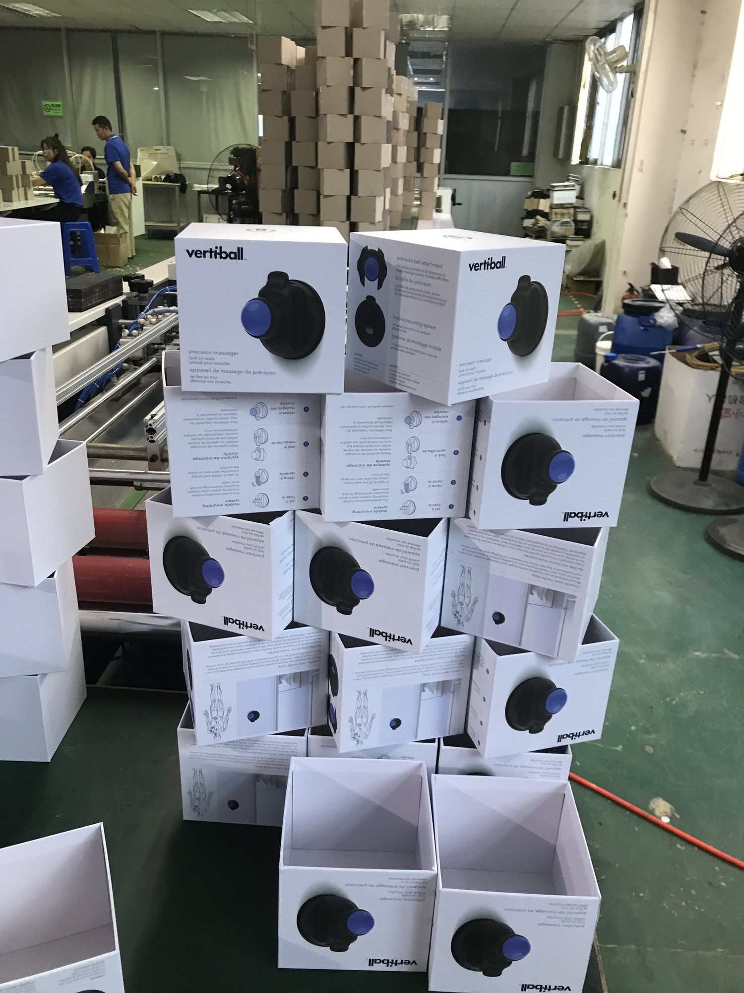 Stacks of Vertiball retail boxes on a factory floor.